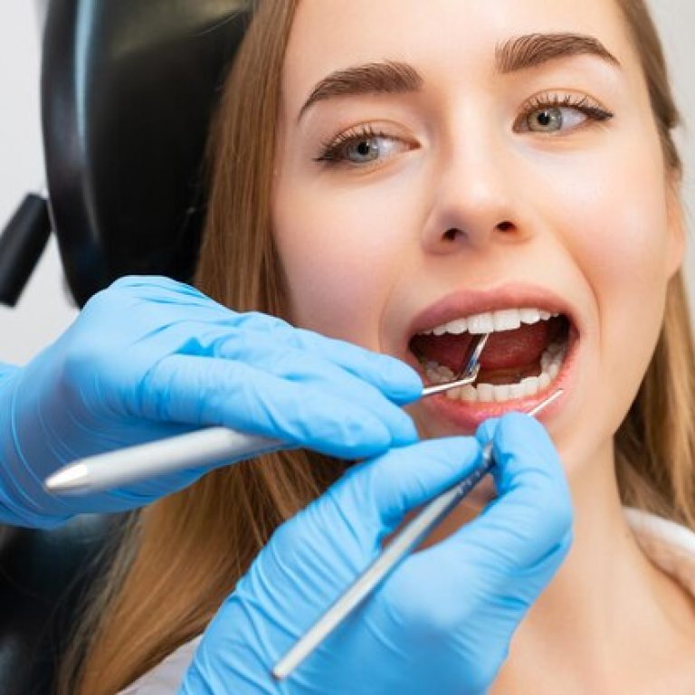 mujer-paciente-sentada-silla-procedimientos-dentales-clinica-dental-dentista-comprueba-dientes-delanteros_177415-2665